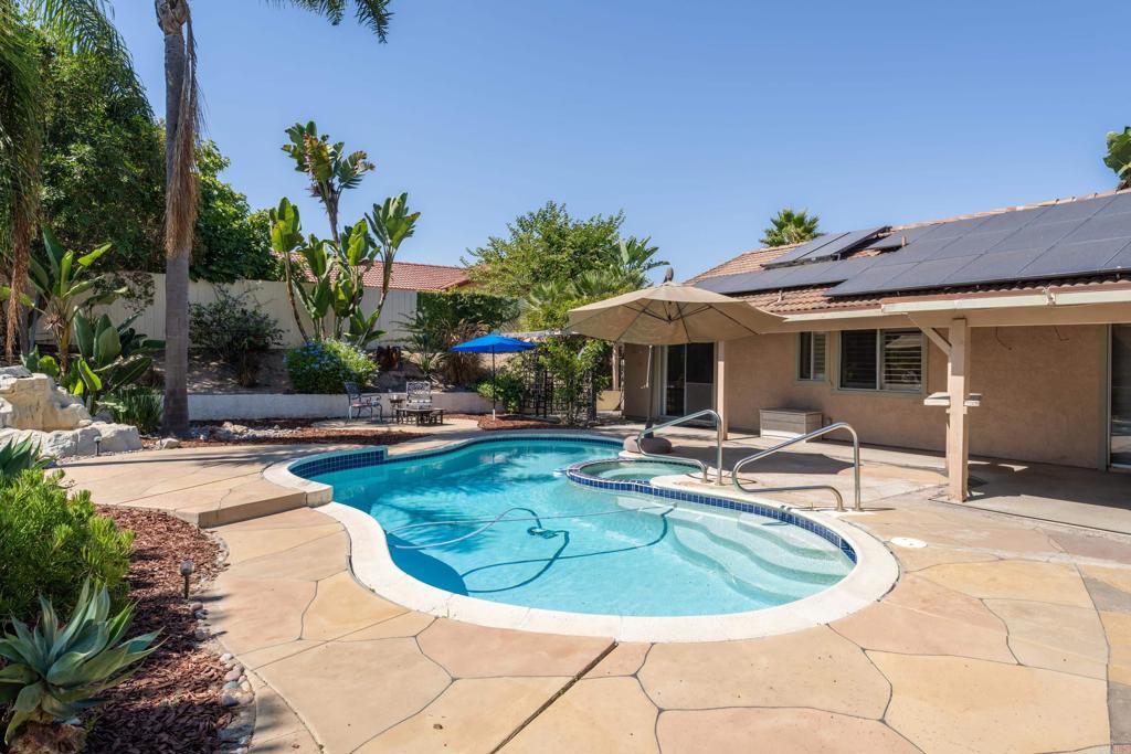 a view of a house with swimming pool and sitting area