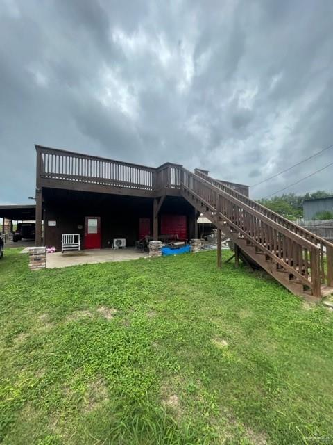 a view of a house with a yard and deck