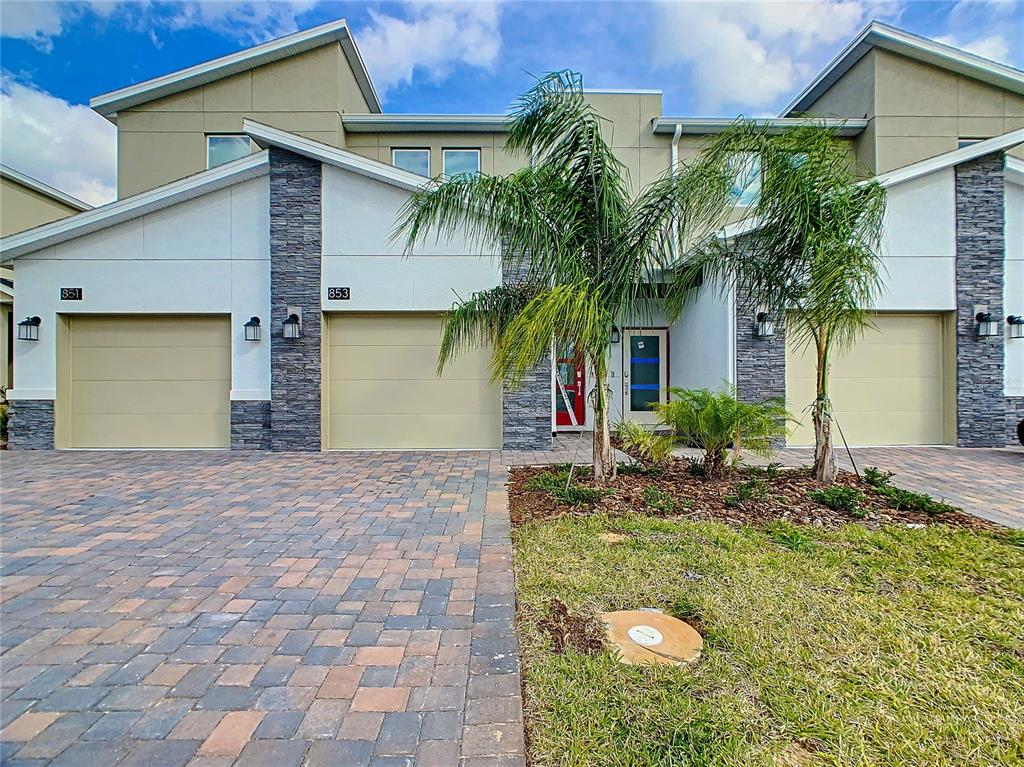 a front view of house along with trees and entryway