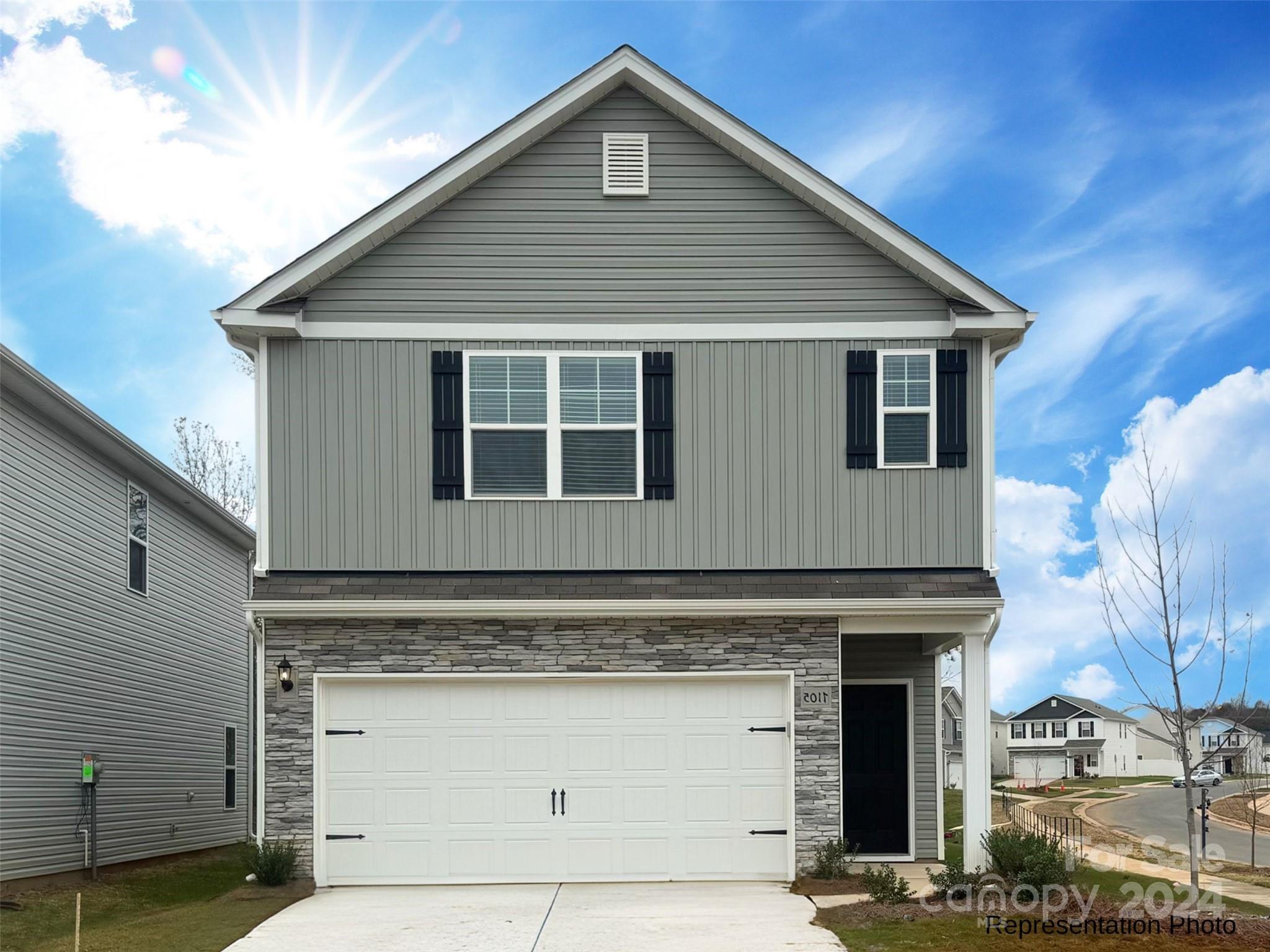 a front view of a house with a garage