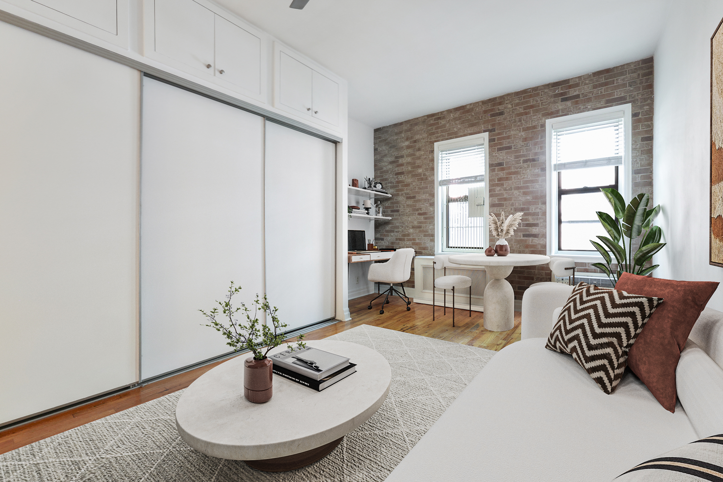 a living room with furniture and a potted plant