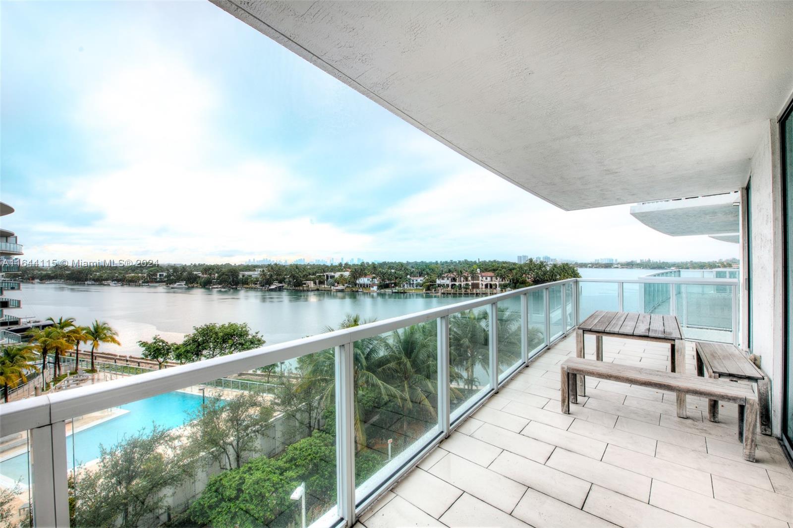 a view of swimming pool with a lake from a balcony