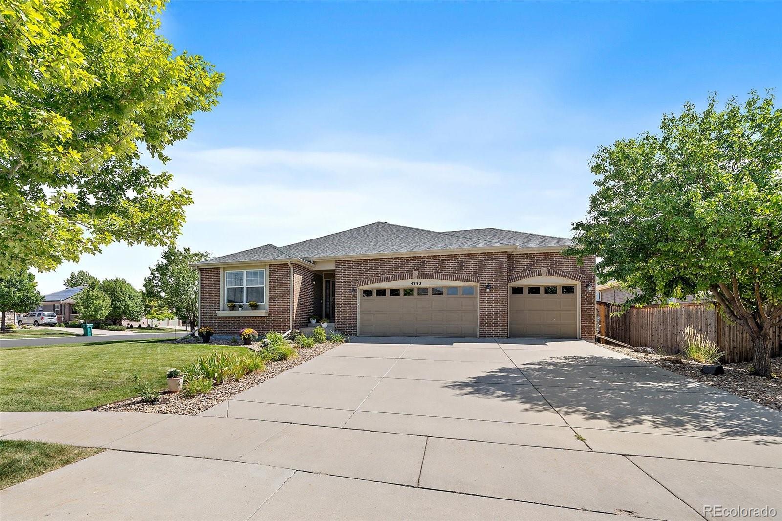 a front view of a house with a yard and a garage