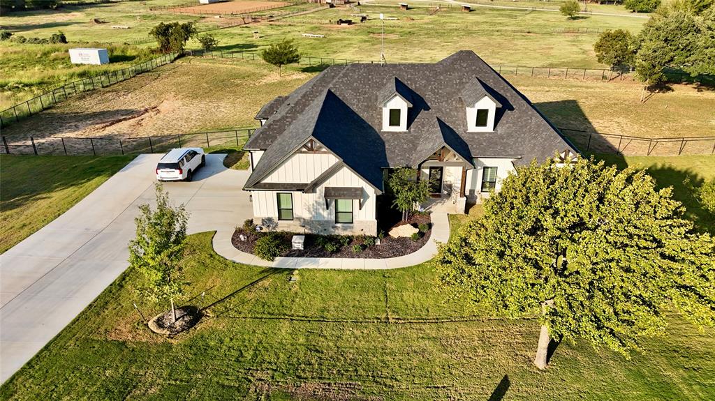 a aerial view of a house with swimming pool and ocean view