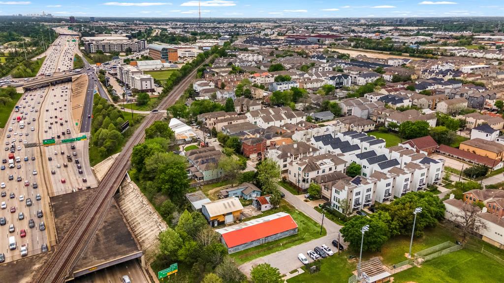 an aerial view of residential houses with outdoor space