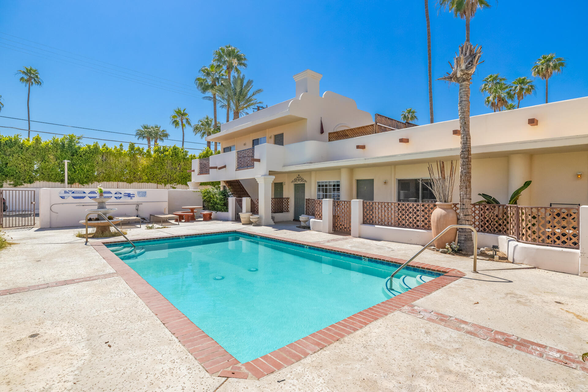 a view of a house with swimming pool and sitting area