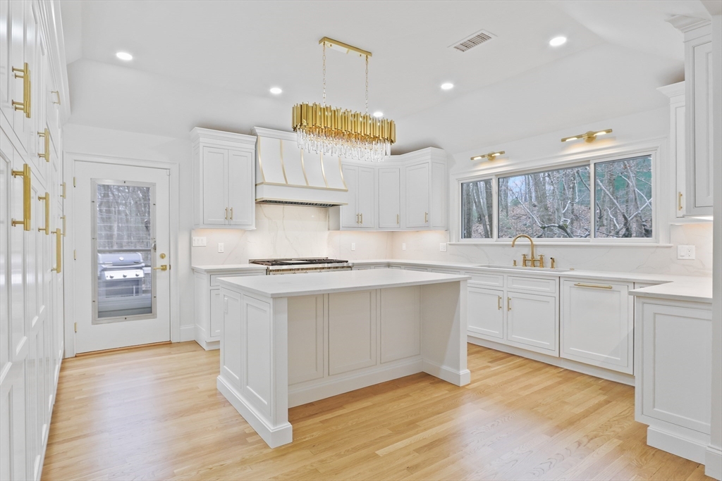 a kitchen with stainless steel appliances granite countertop a sink and cabinets