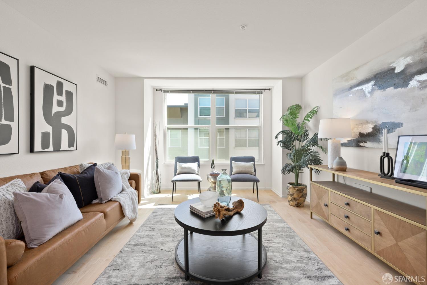 a living room with furniture and a potted plant