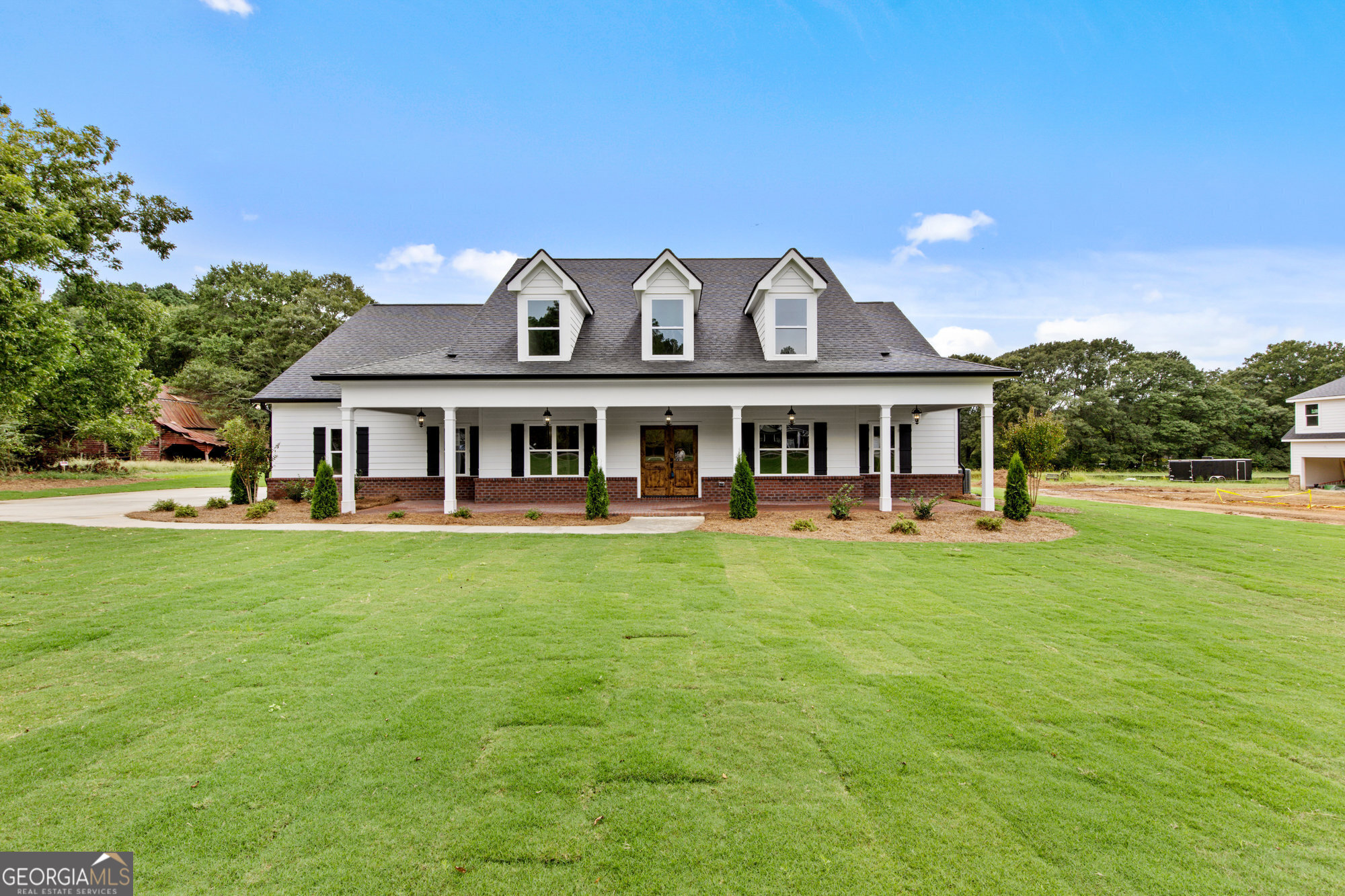 a front view of a house with a garden