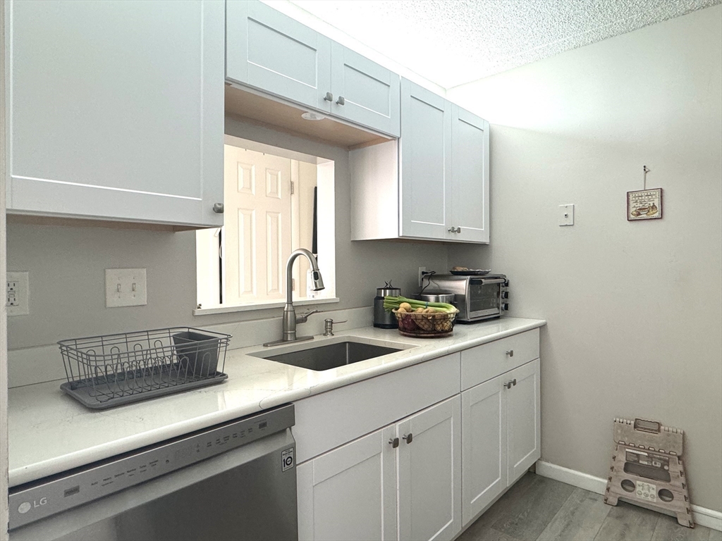 a kitchen with a sink cabinets and window