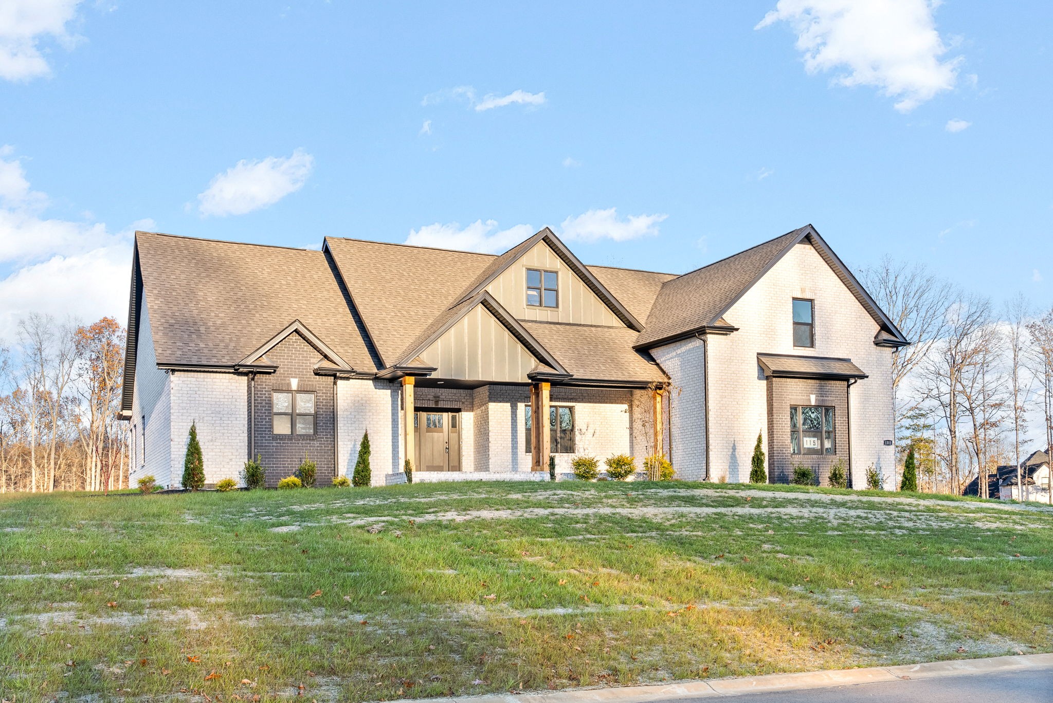 a view of a big house with a big yard and potted plants