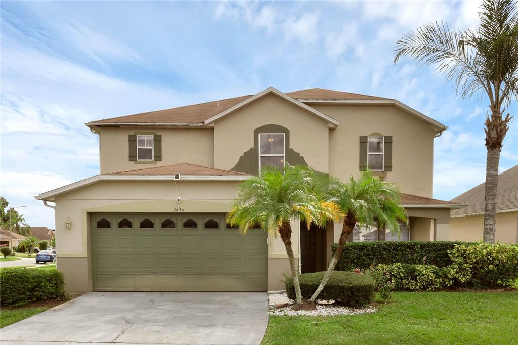 a front view of a house with a yard and garage