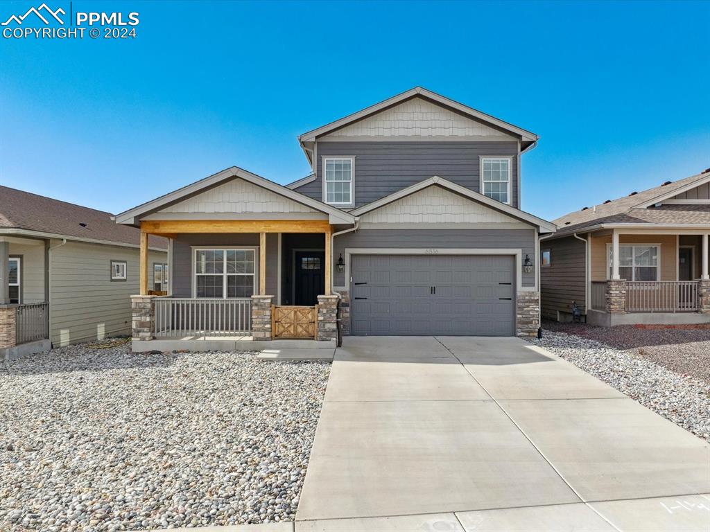 Craftsman-style house with a porch and a garage