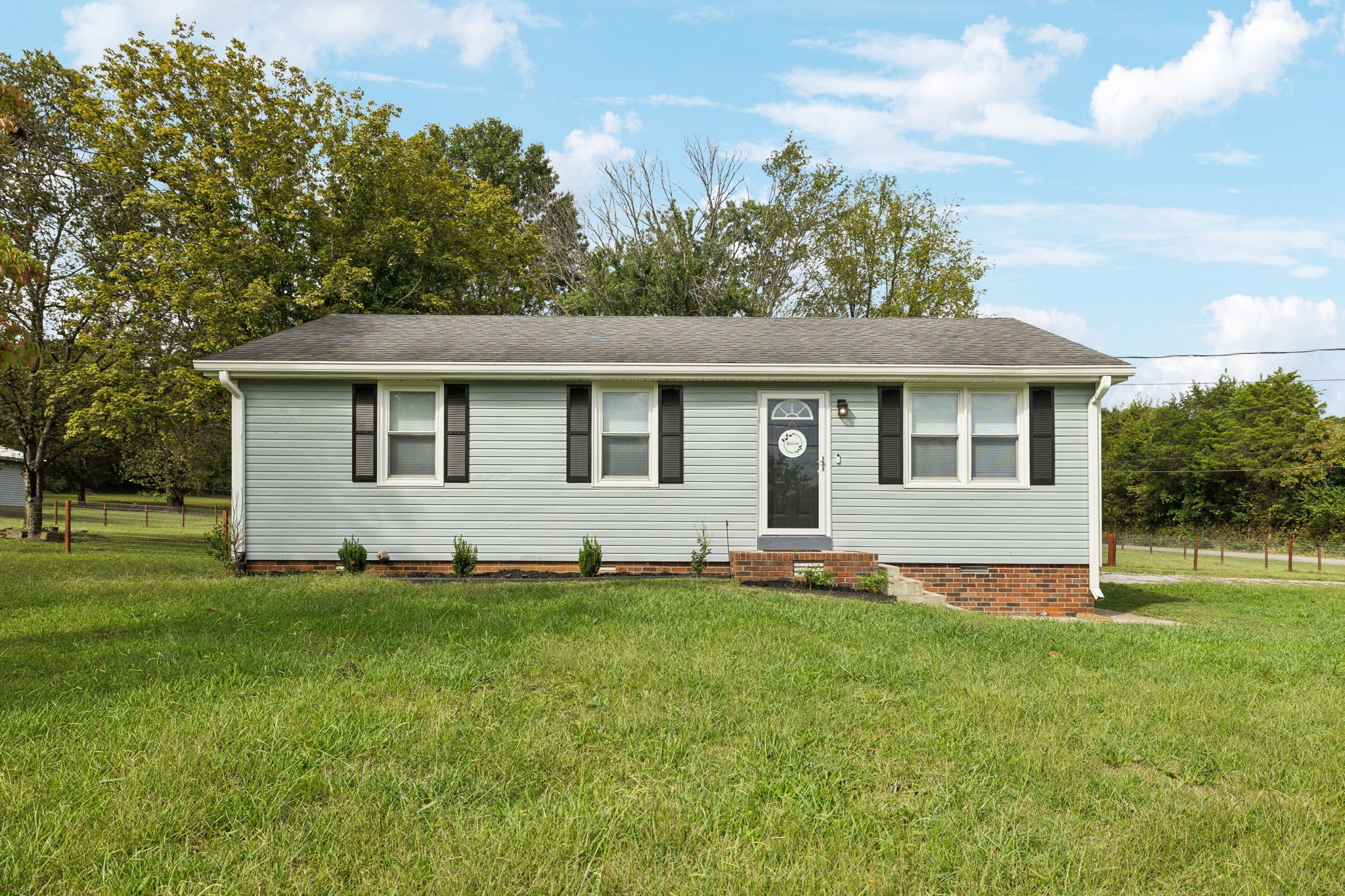 a front view of a house with a yard