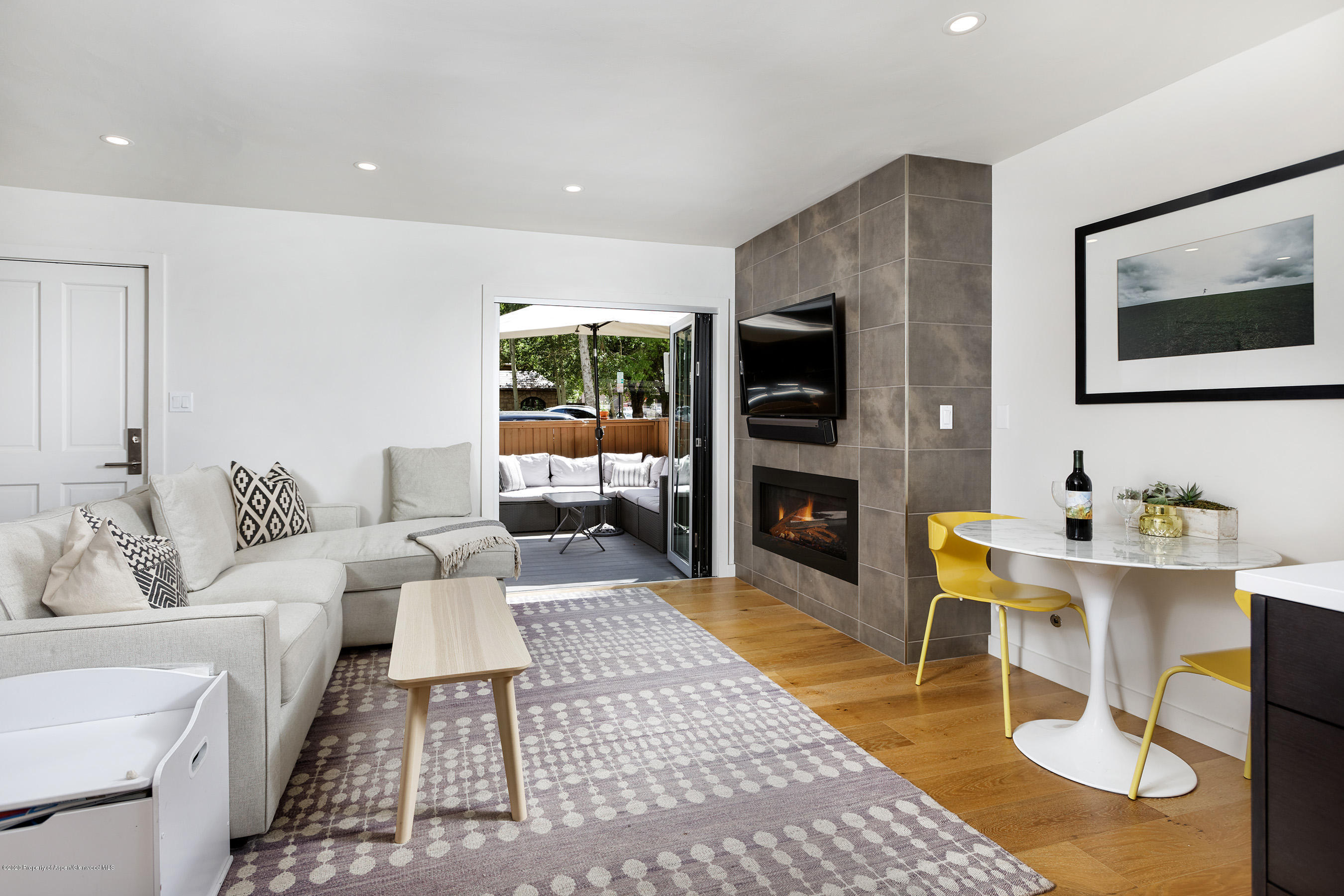 a living room with furniture a rug and a flat screen tv