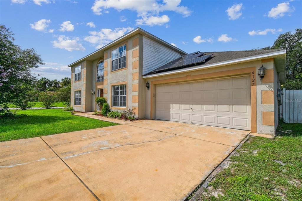 a front view of house with yard and green space