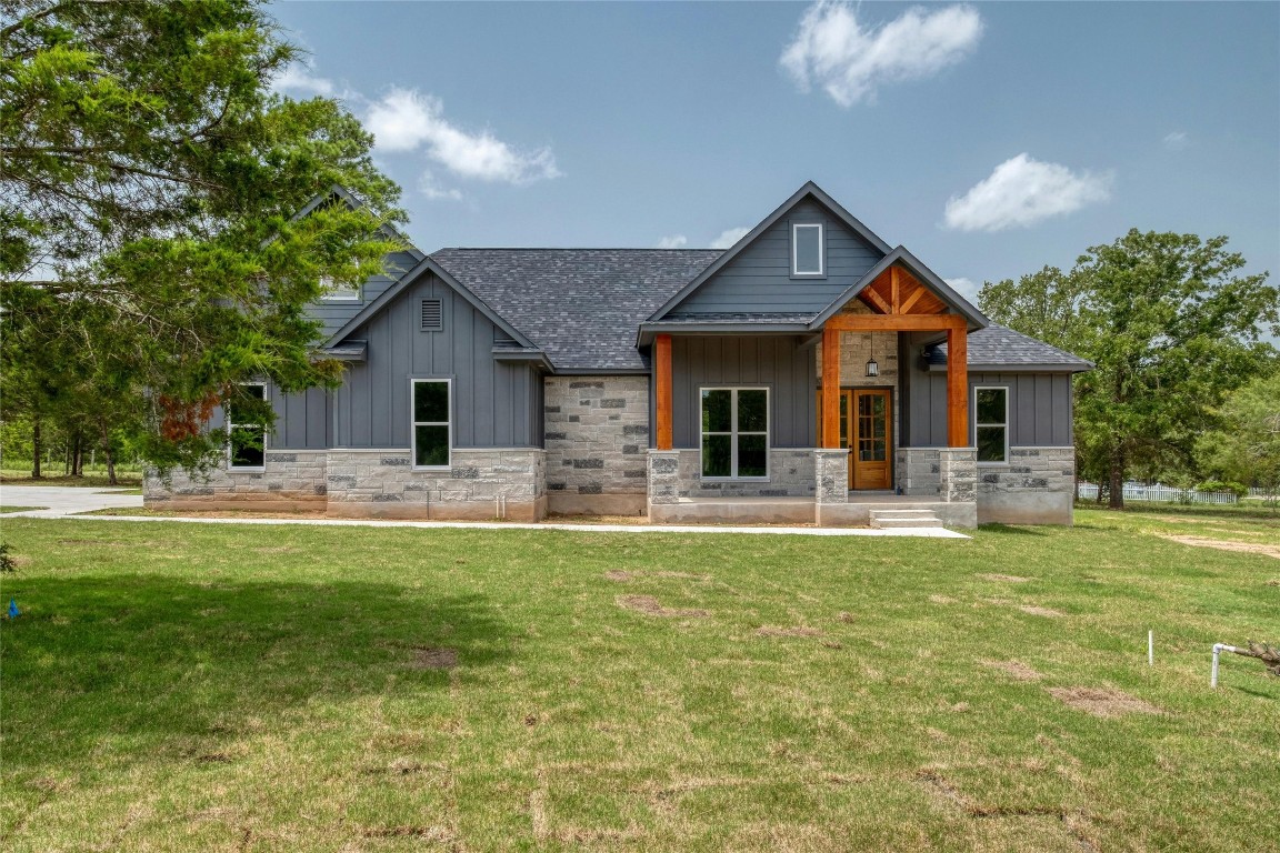 a front view of a house with swimming pool having outdoor seating