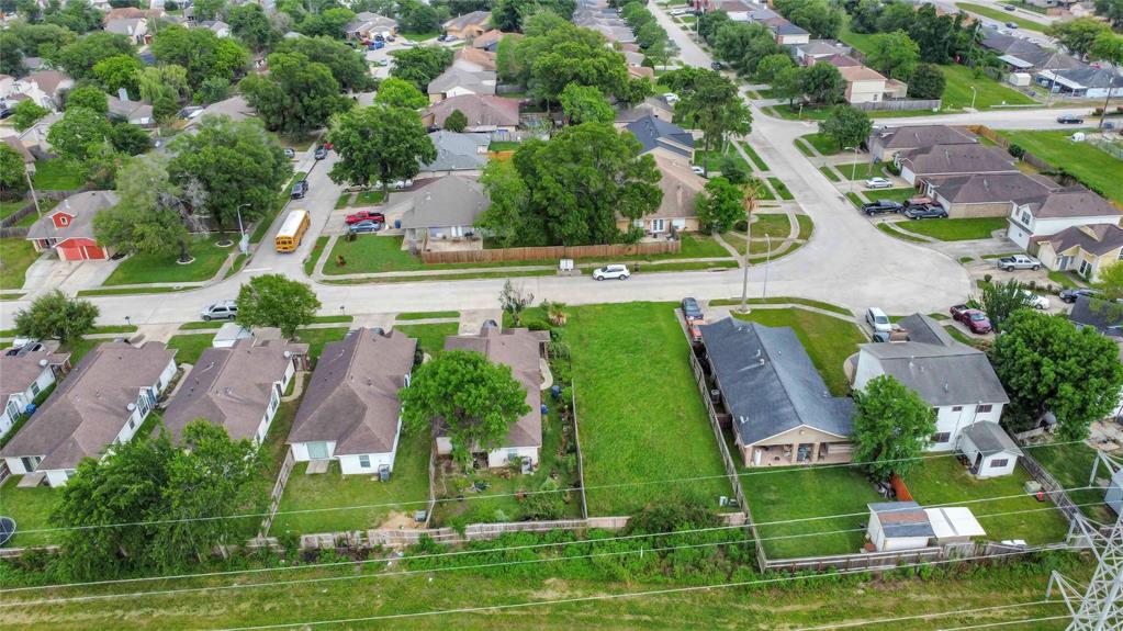 an aerial view of multiple houses with yard