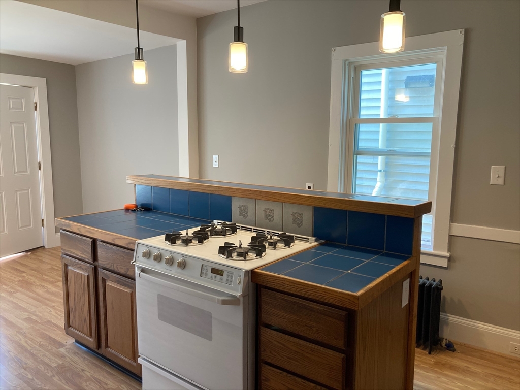 a kitchen that has a stove and a table in it