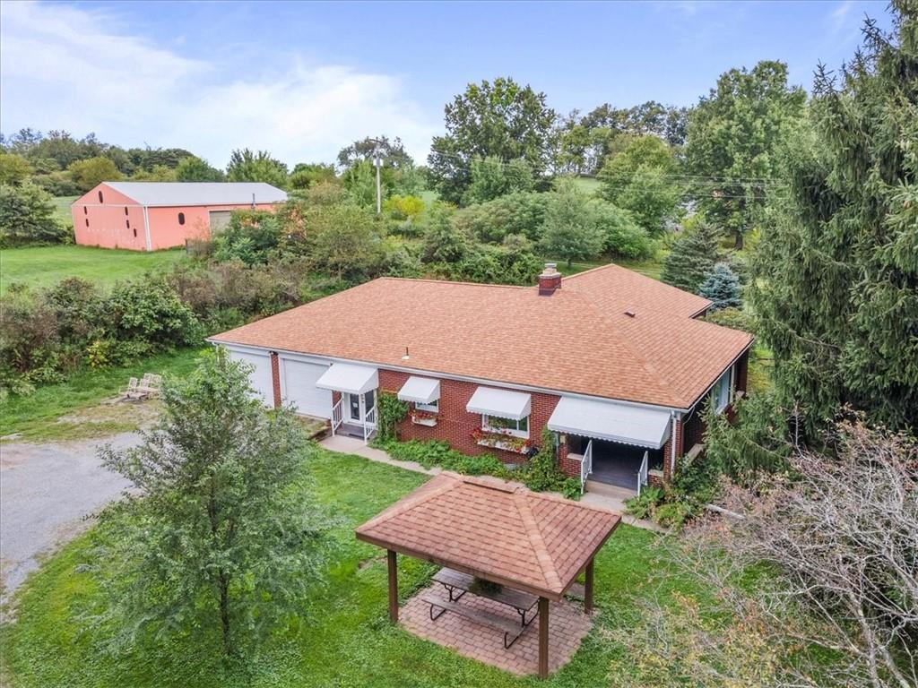 an aerial view of a house with yard and outdoor seating