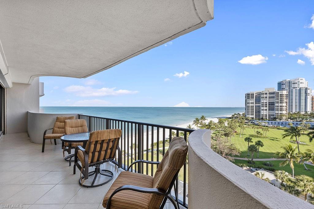 a balcony with table and chairs