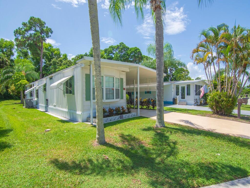 a view of a house with swimming pool and a yard