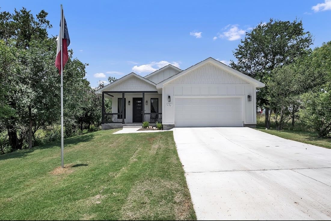 a front view of house with yard and green space