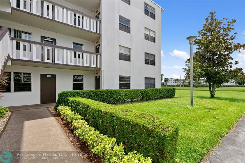 a view of an apartment with a garden