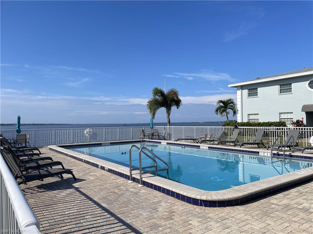 View of pool with a water view