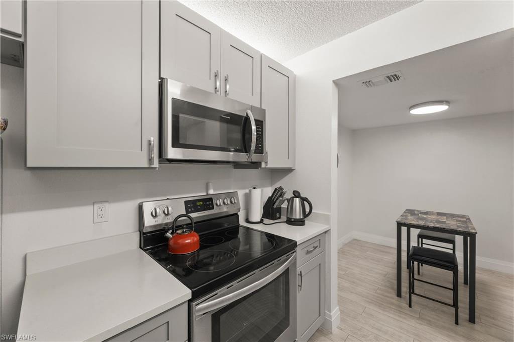 a kitchen with a stove and a microwave