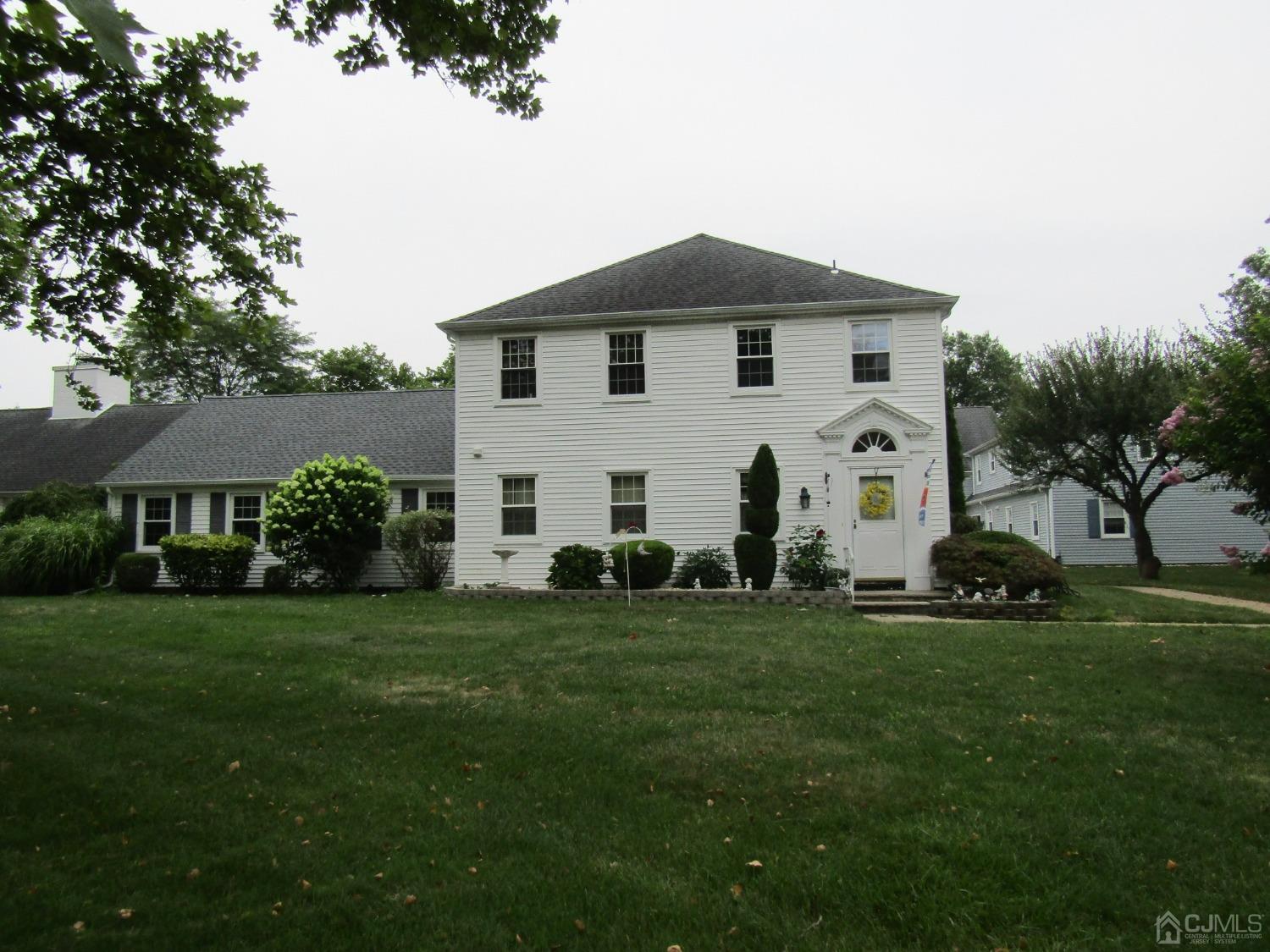 a view of a white house with a yard