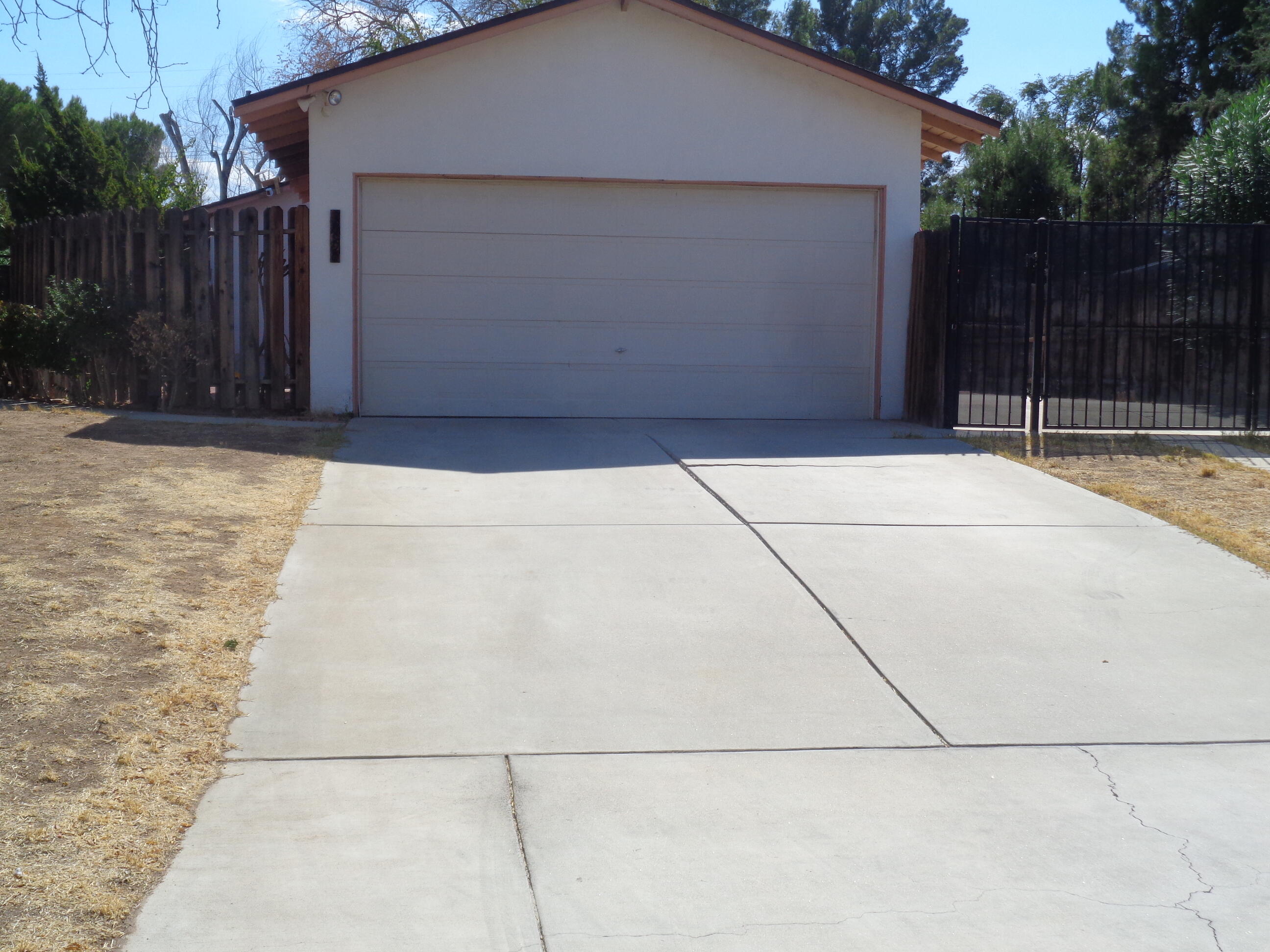 a backyard of house with wooden fence