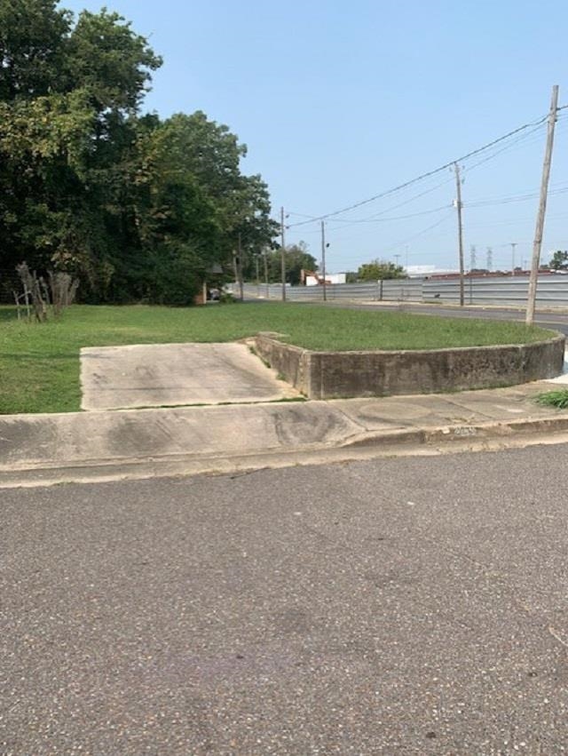 a view of a road with a big yard