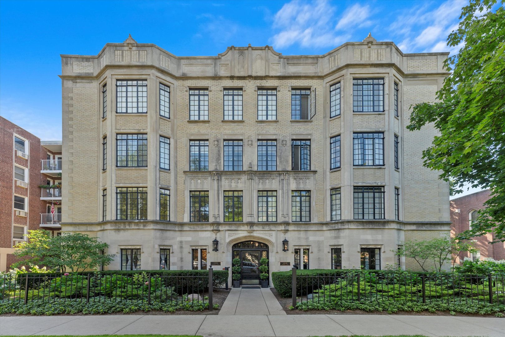 a front view of a residential apartment building with a yard