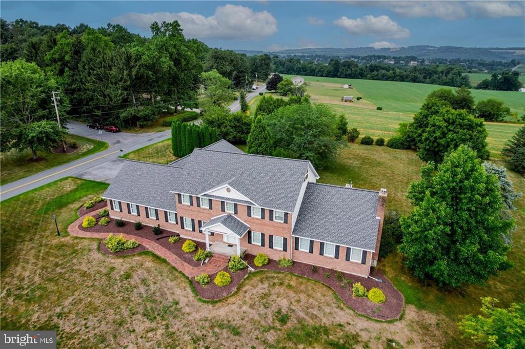 an aerial view of a house with garden space and street view