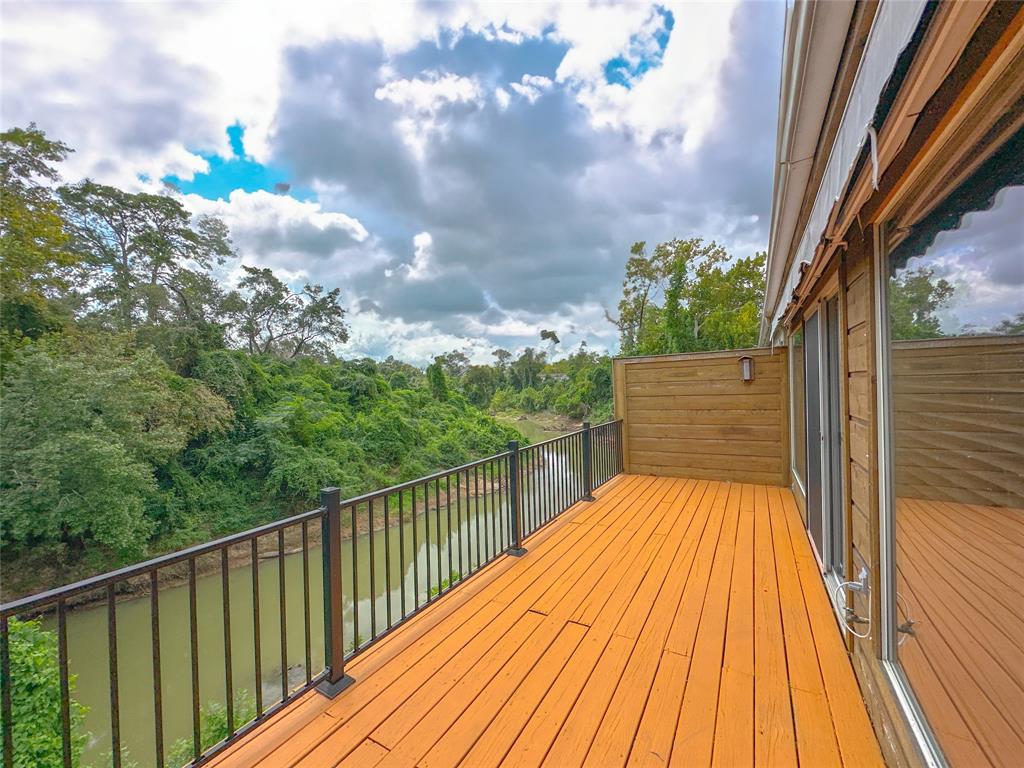 a view of balcony with wooden floor and fence