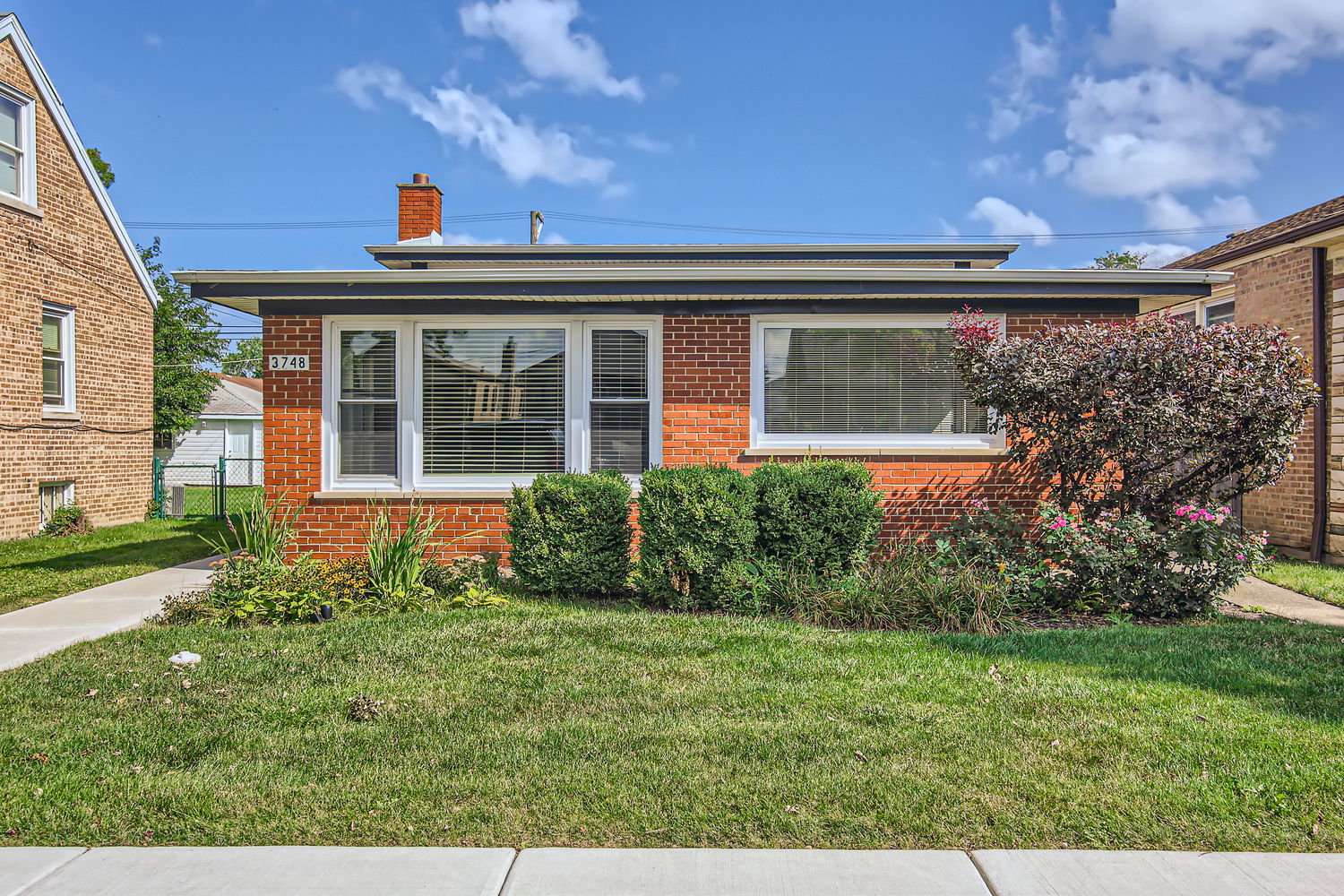 front view of a house with a yard