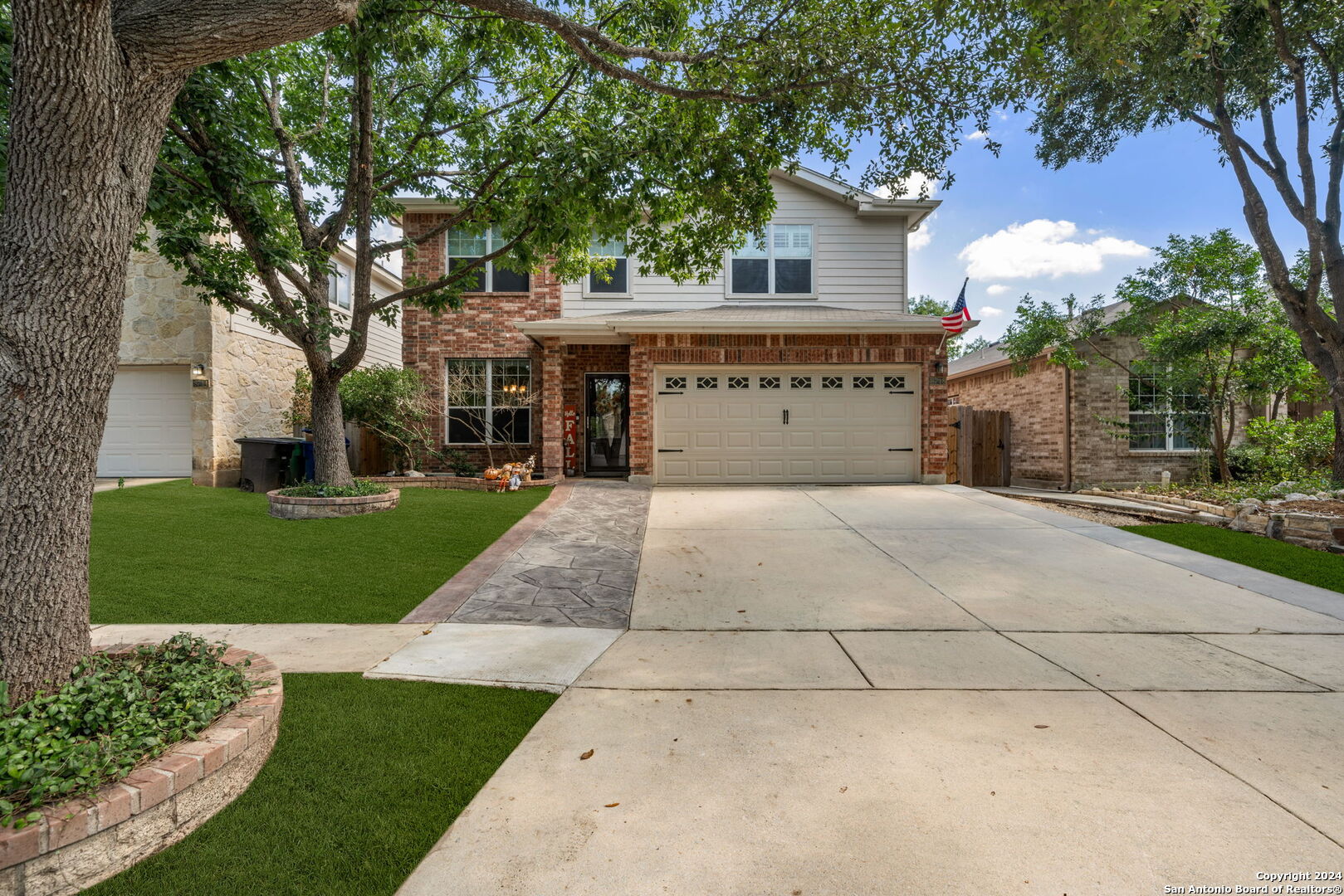 a large house with a large tree in front of it