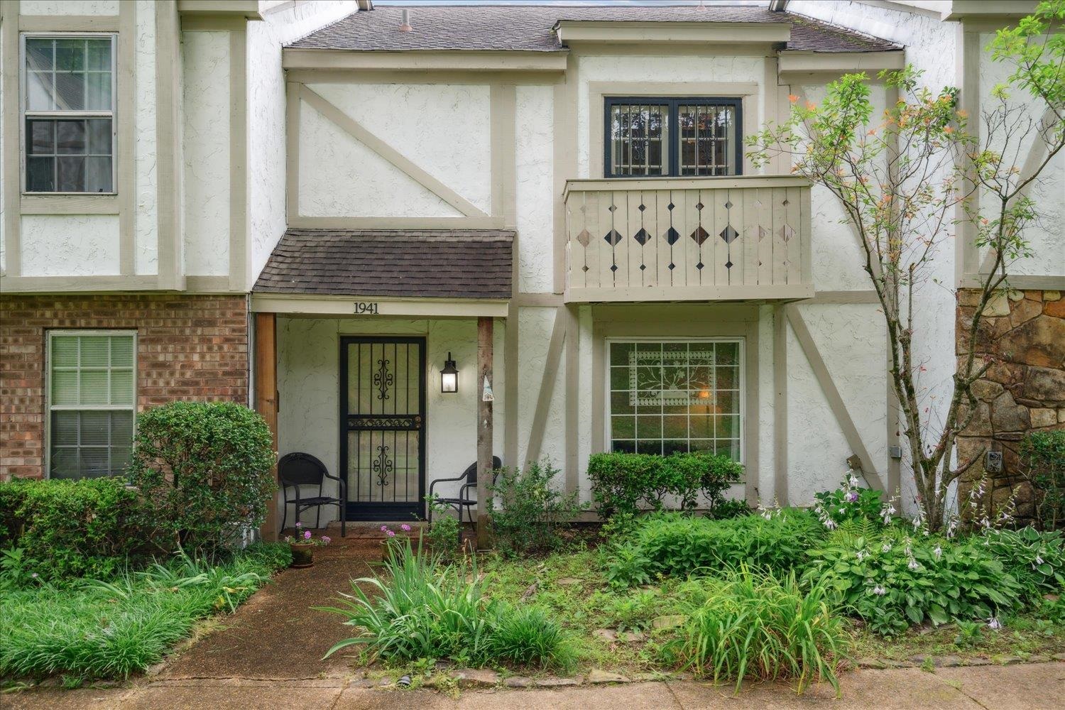 front view of a brick house with a small yard