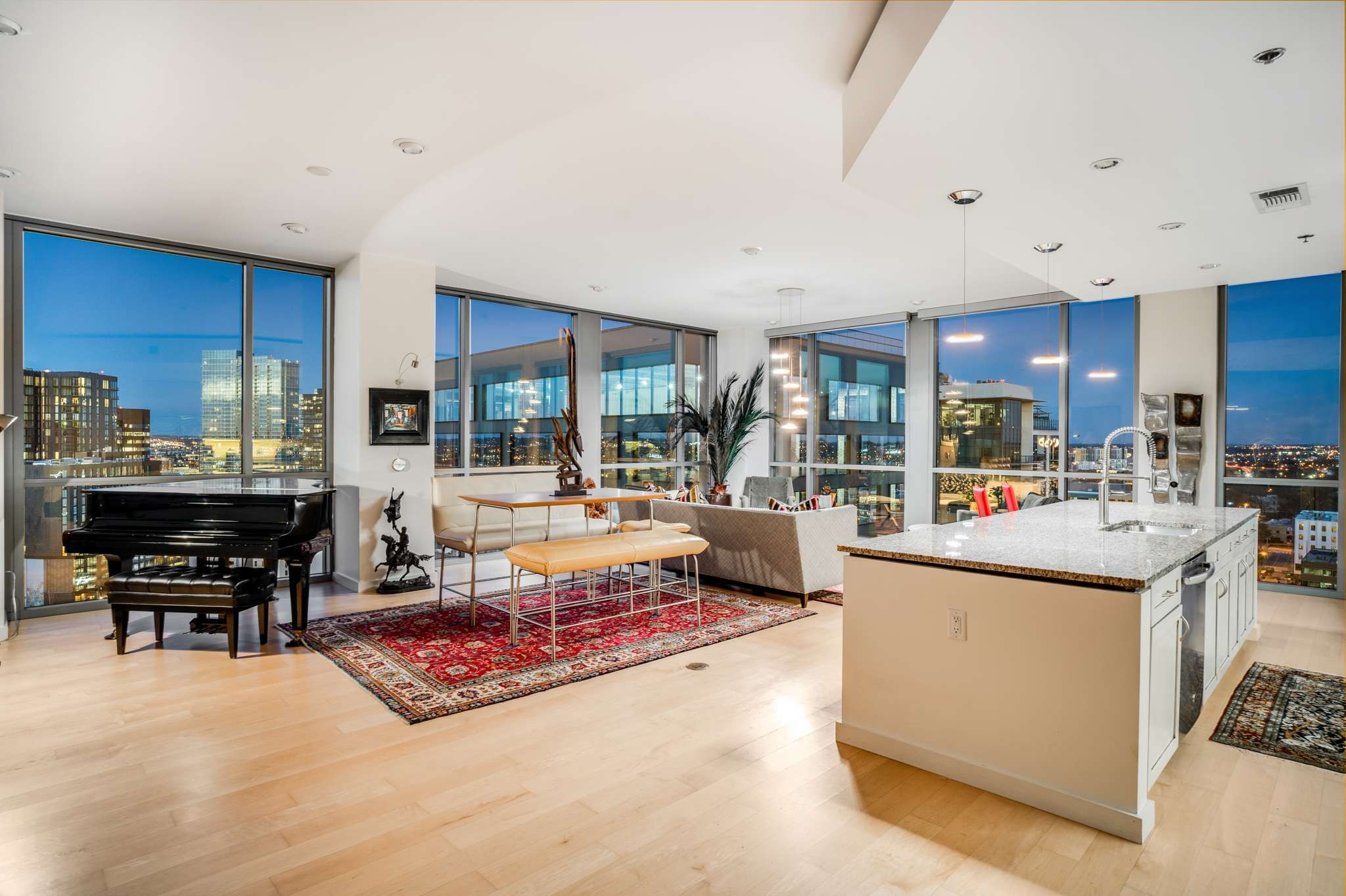 a living room with furniture and a dining table with kitchen view