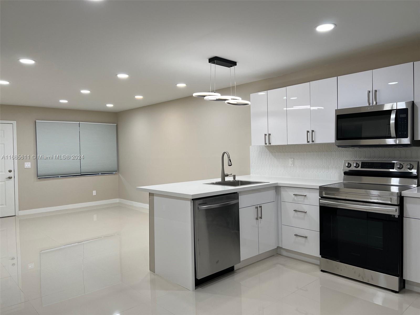 a kitchen with a sink and a stove top oven