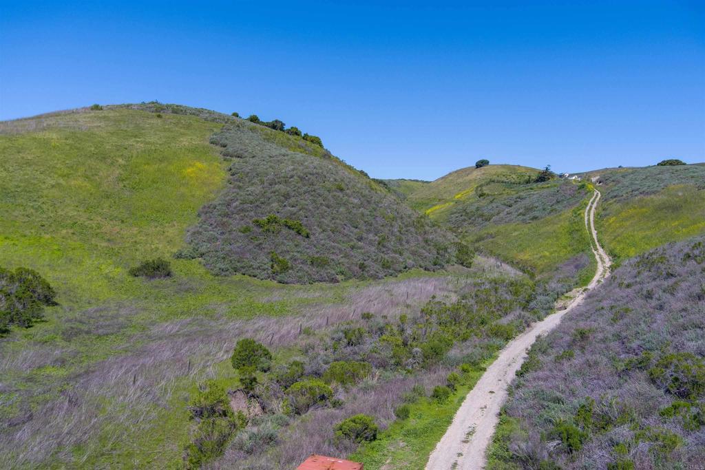 a view of a mountain with a yard