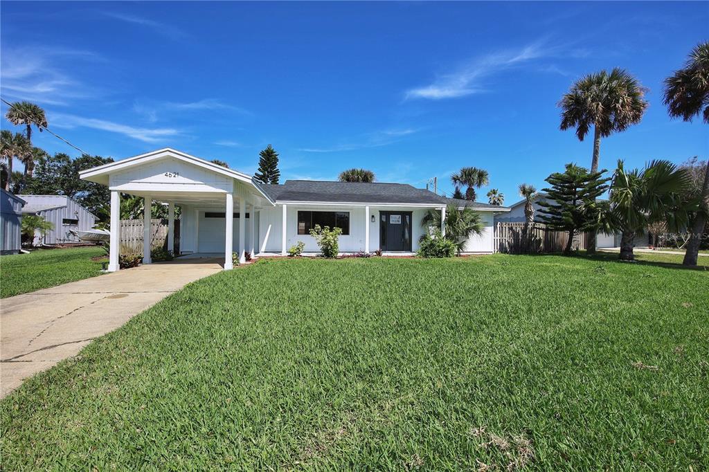 a front view of a house with a yard