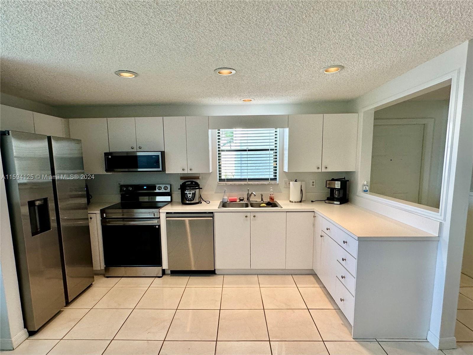 a kitchen with cabinets and stainless steel appliances