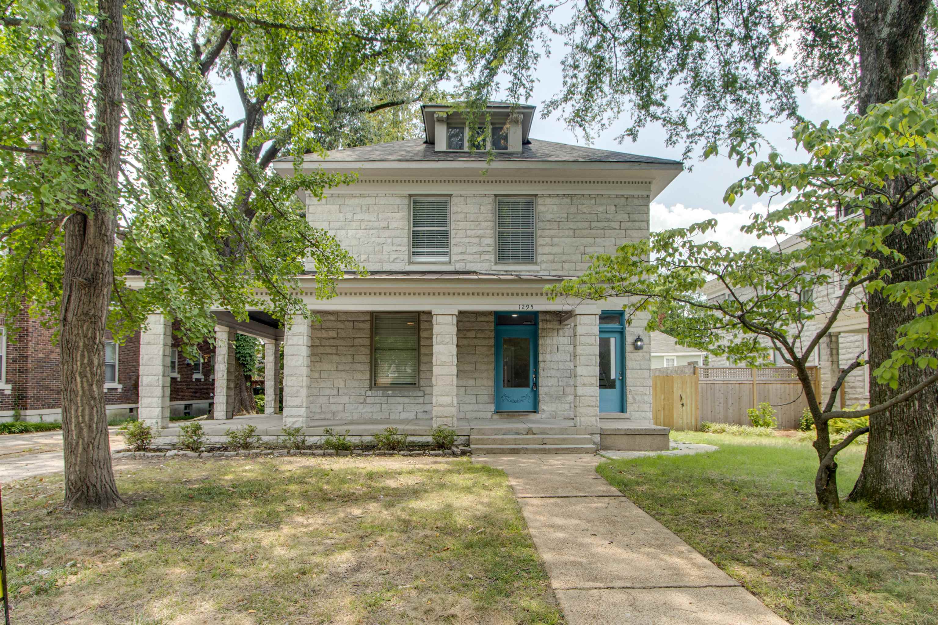 a front view of a house with a garden