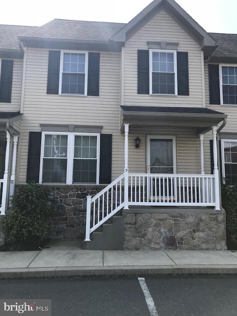 a view of a house with a small yard