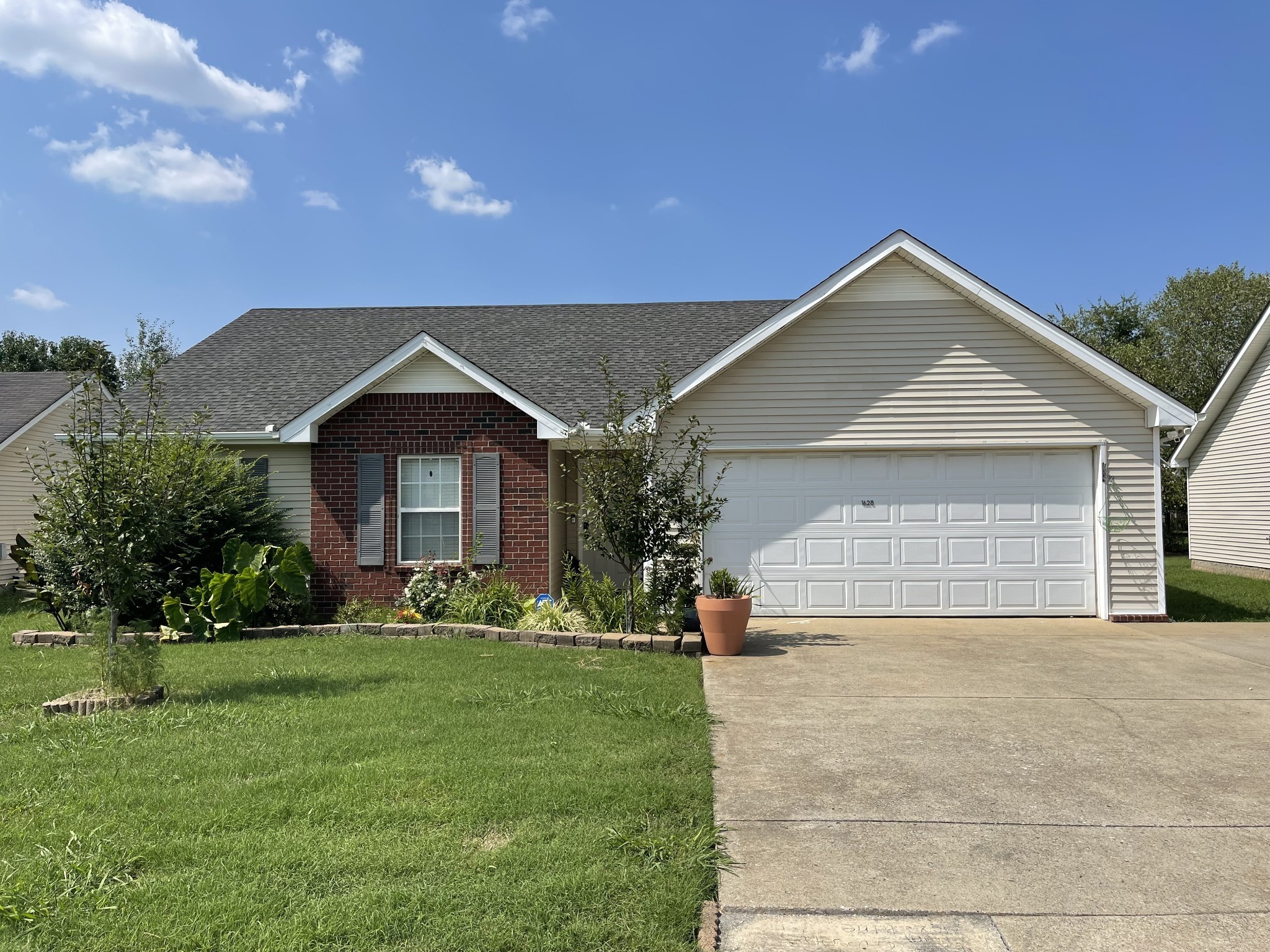 a front view of a house with a yard and garage