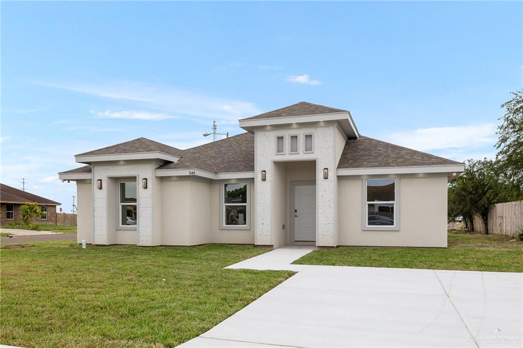 a front view of a house with a yard