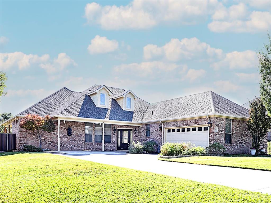 a view of a house with swimming pool and a yard