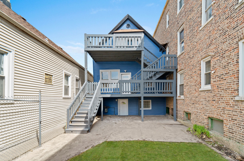 a view of a house with a yard and deck